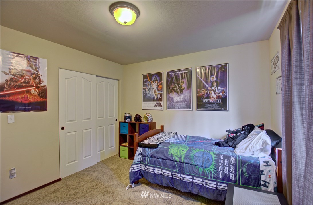 5138 180th Trail Southwest Rochester, WA 98579 - Photo 22 of 33 a bed room with a bed and a window
