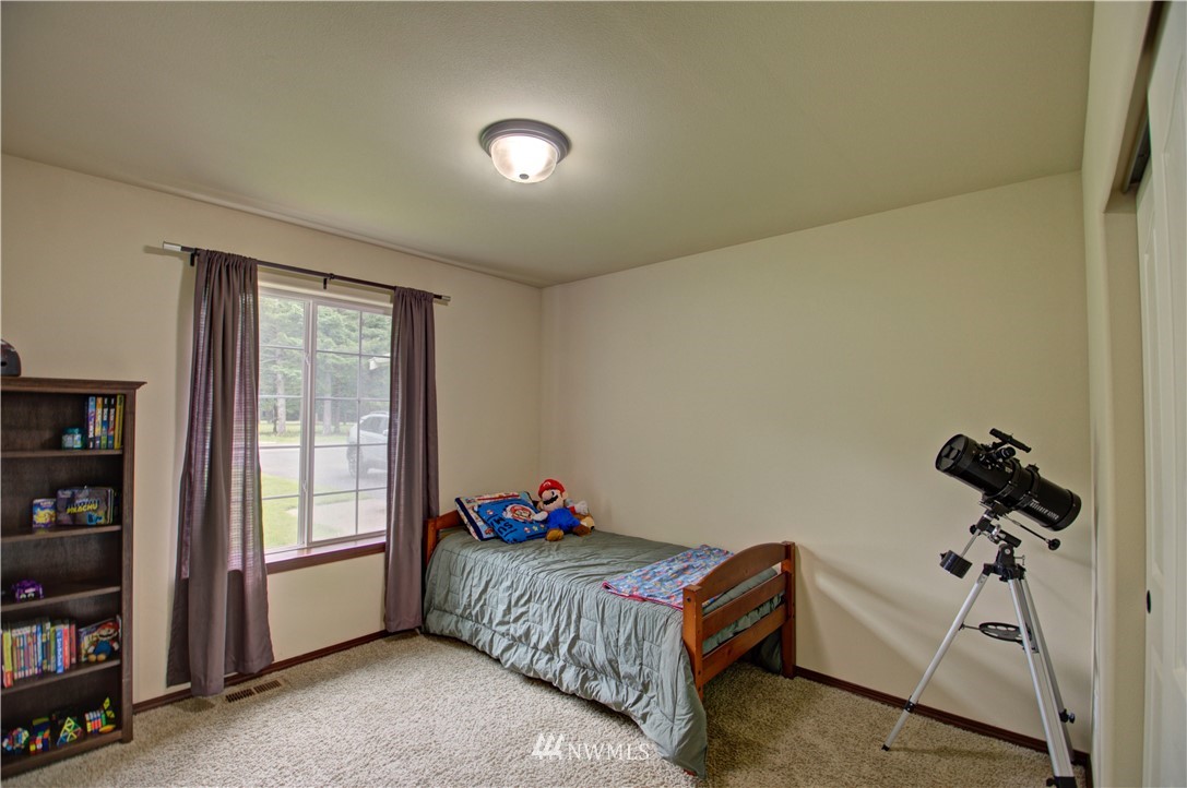 5138 180th Trail Southwest Rochester, WA 98579 - Photo 23 of 33 a bedroom with a bed and a window