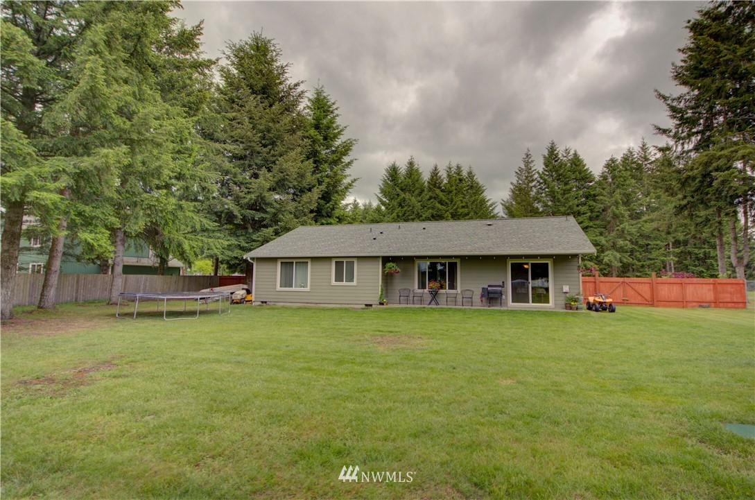 5138 180th Trail Southwest Rochester, WA 98579 - Photo 27 of 33 a view of a house with a big yard and large trees