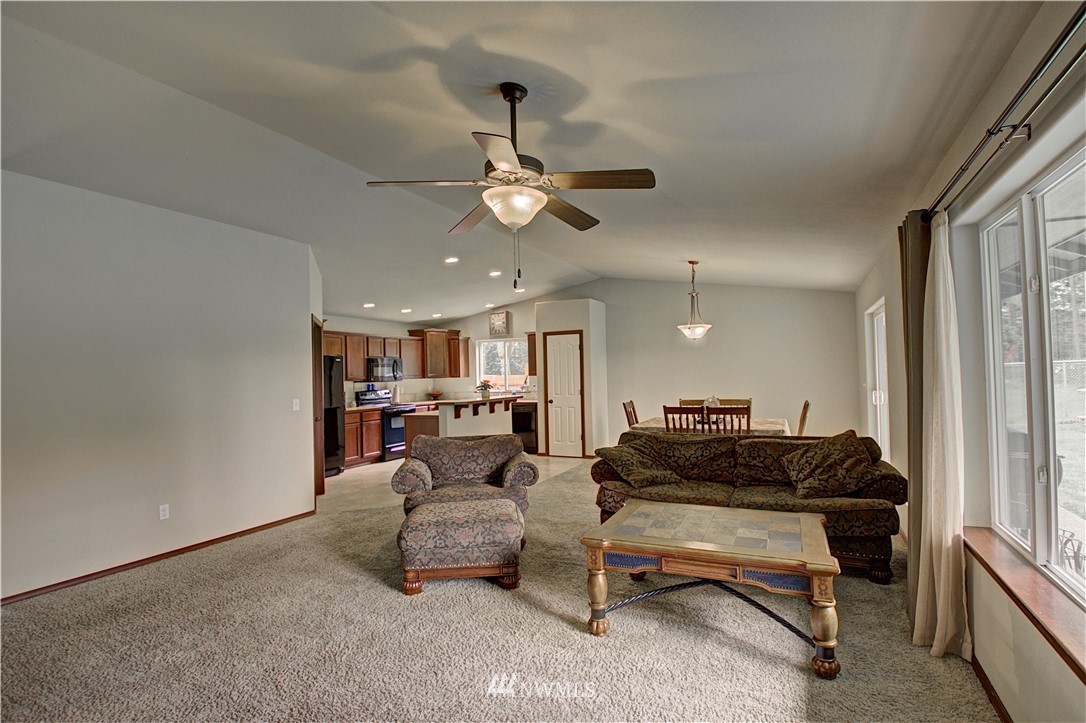 5138 180th Trail Southwest Rochester, WA 98579 - Photo 4 of 33 a living room with furniture a ceiling fan and a window