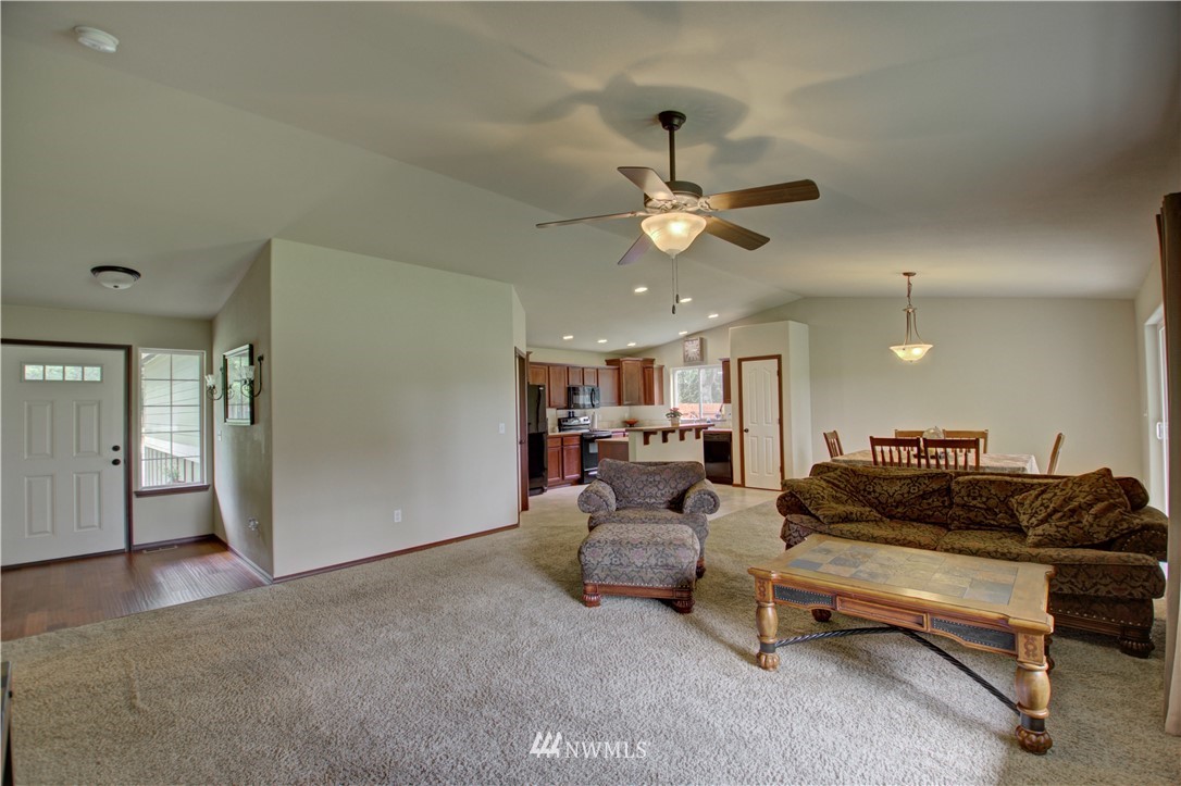 5138 180th Trail Southwest Rochester, WA 98579 - Photo 5 of 33 a living room with furniture and a chandelier