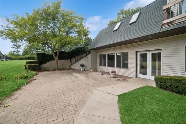 a view of a house with backyard and sitting area