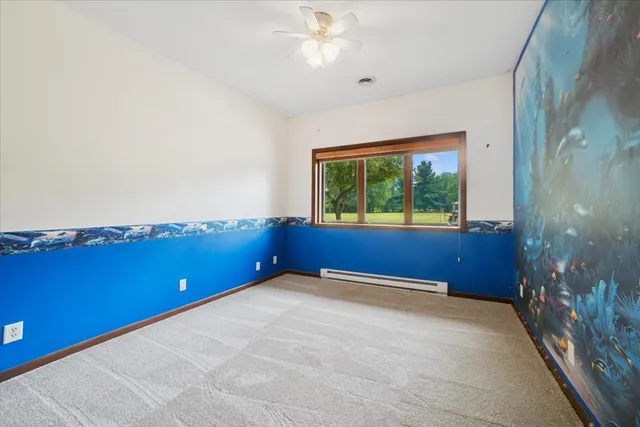 a spacious bedroom with a bed and a large window