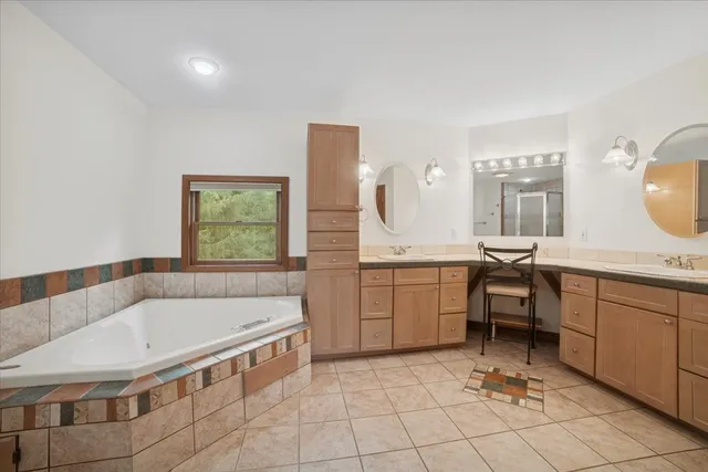 a bathroom with a tub and a shower