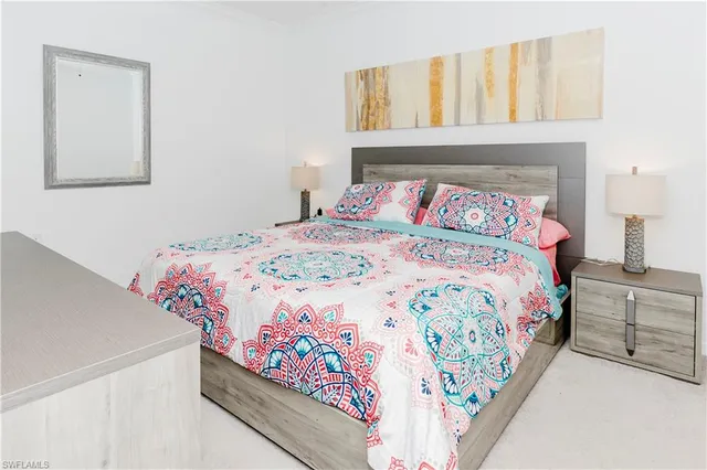 a bedroom with a bed and a painting on the wall