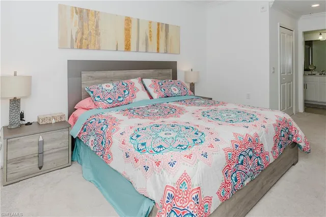 a bedroom with a bed and painting on the wall