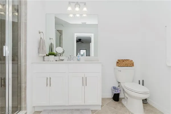 a bathroom with a sink a toilet and mirror
