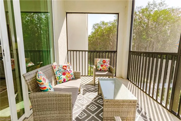 a living room with furniture and a floor to ceiling window