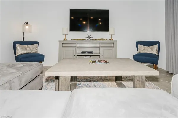 a living room with furniture and flat screen tv