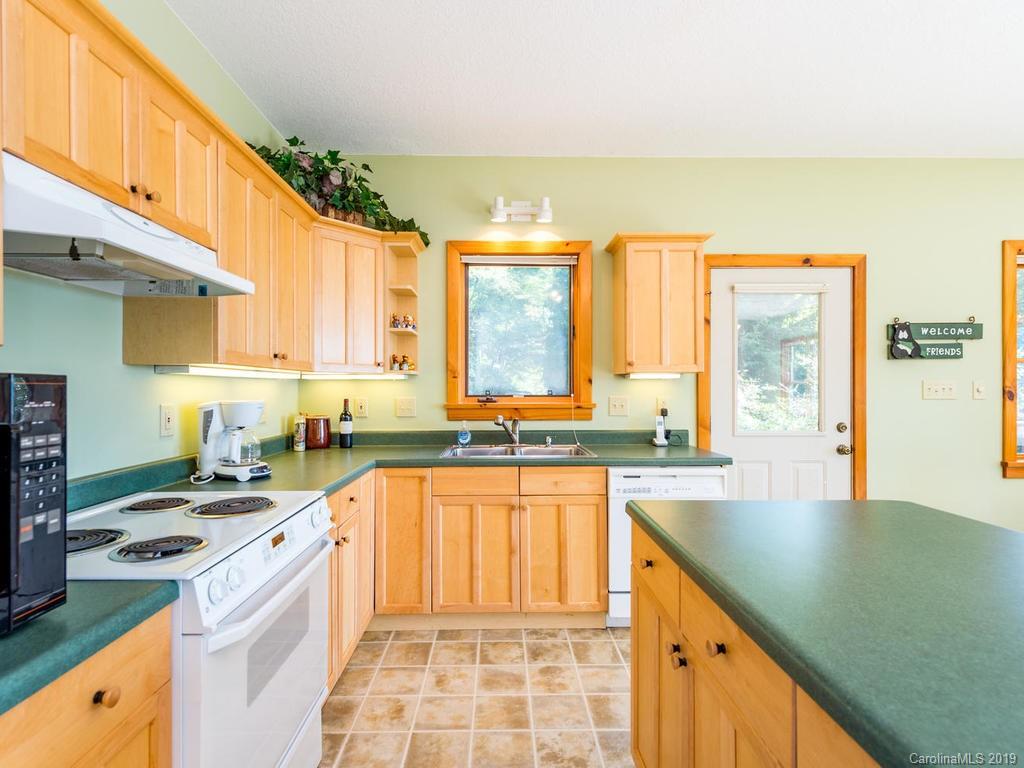 1299 Pine Ridge Road Burnsville, NC 28714 - Photo 15 of 41 a kitchen with a sink stove and cabinets