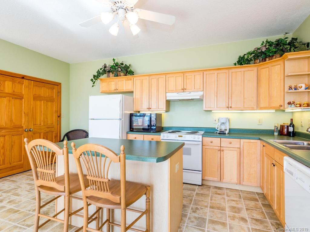 1299 Pine Ridge Road Burnsville, NC 28714 - Photo 16 of 41 a kitchen with granite countertop a stove a sink and a granite counter tops