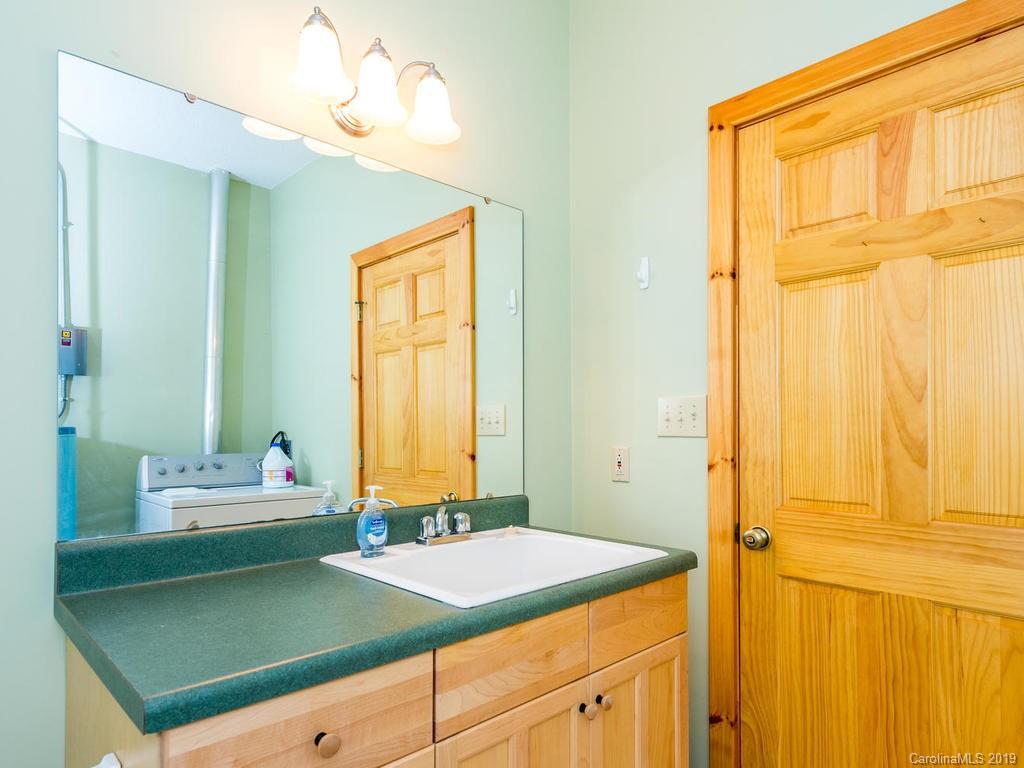1299 Pine Ridge Road Burnsville, NC 28714 - Photo 17 of 41 a bathroom with a sink and a mirror