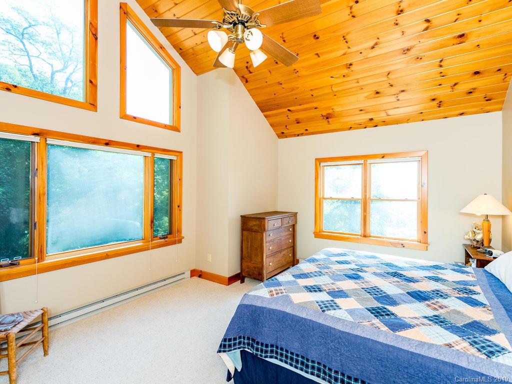 1299 Pine Ridge Road Burnsville, NC 28714 - Photo 20 of 41 a bedroom with a bed and a window