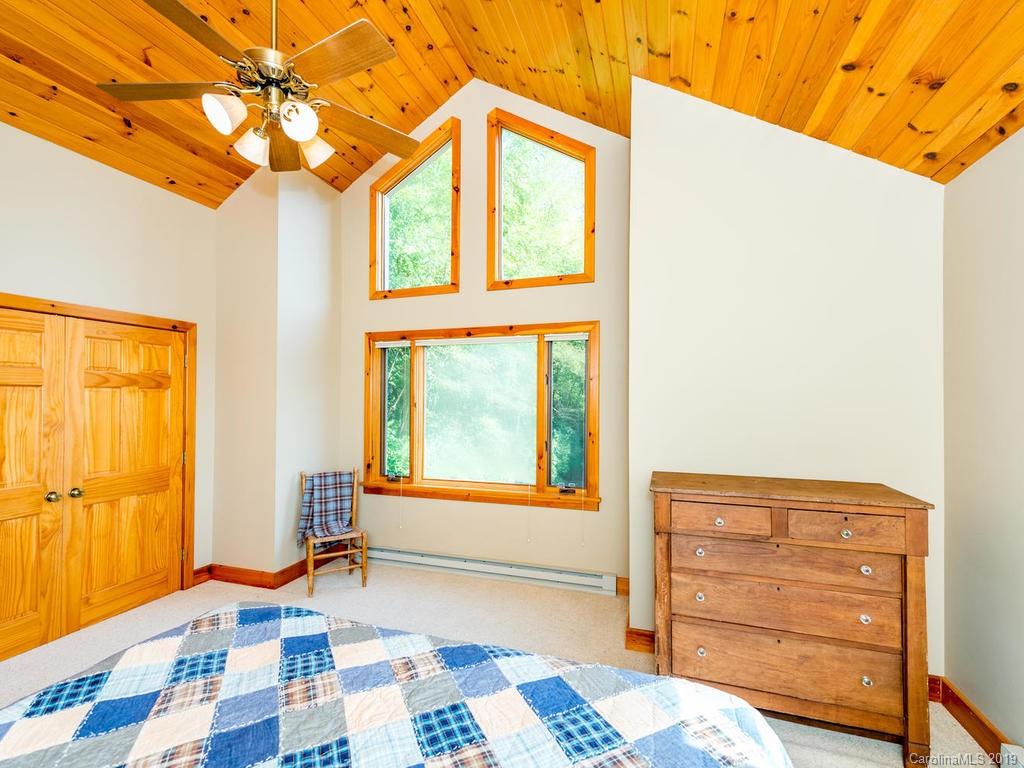 1299 Pine Ridge Road Burnsville, NC 28714 - Photo 22 of 41 a bedroom with a bed and a window