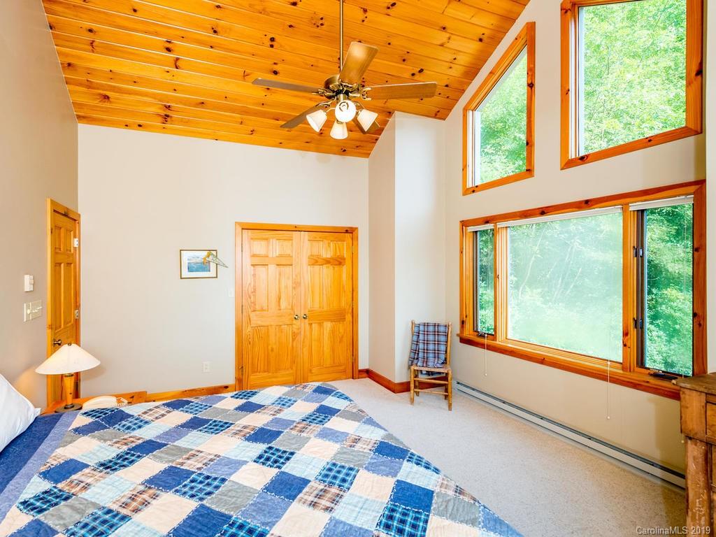 1299 Pine Ridge Road Burnsville, NC 28714 - Photo 23 of 41 a bedroom with a bed and a window