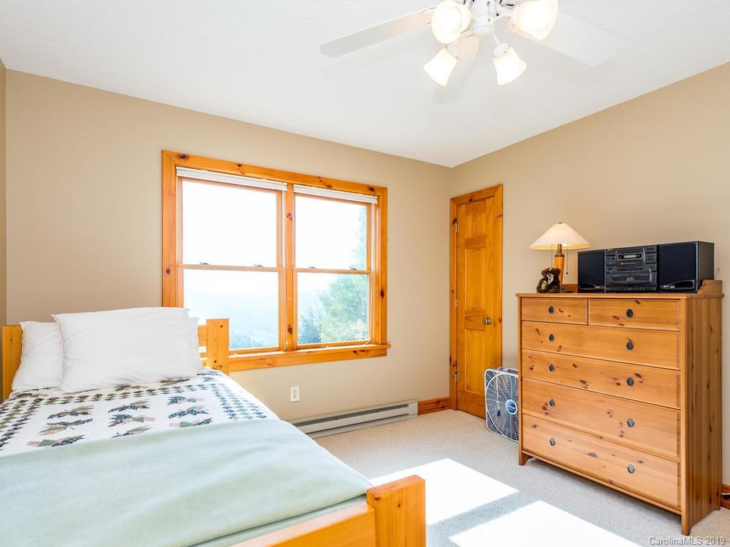 1299 Pine Ridge Road Burnsville, NC 28714 - Photo 27 of 41 a bedroom with a bed and a window