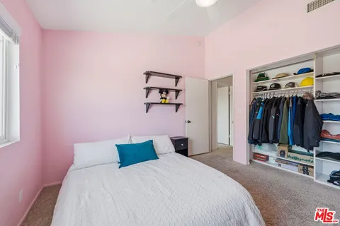 a bedroom with a bed and a mirror