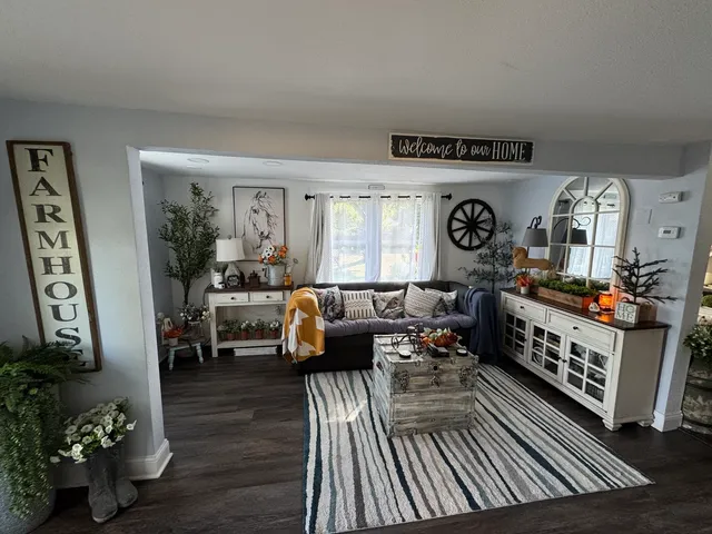 a living room with furniture and a wooden floor