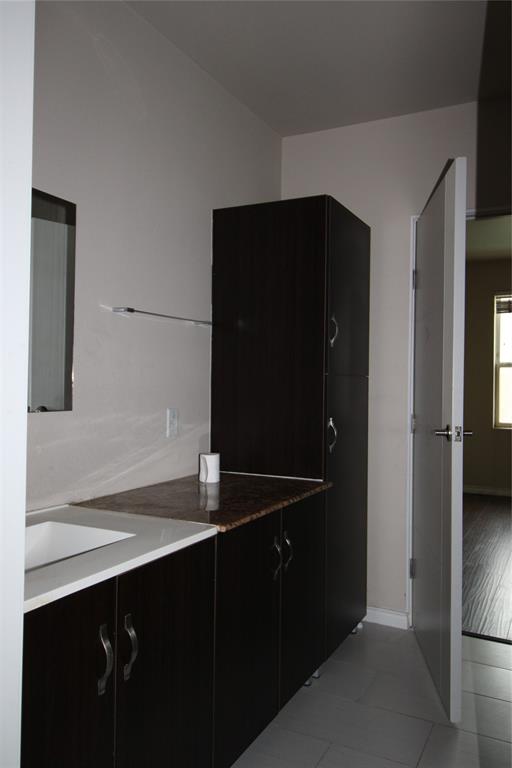 1100 West Trinity Mills Road, Unit 3035 Carrollton, TX 75006 - Photo 11 of 12 a bathroom with a sink and a mirror