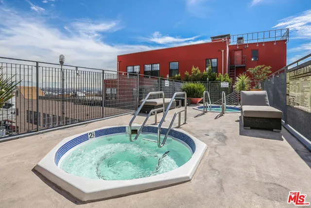 a view of a swimming pool with outdoor seating and plants