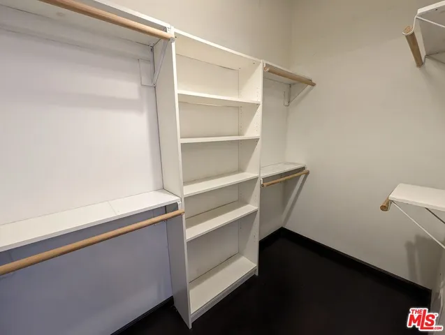 a view of walk in closet with empty racks