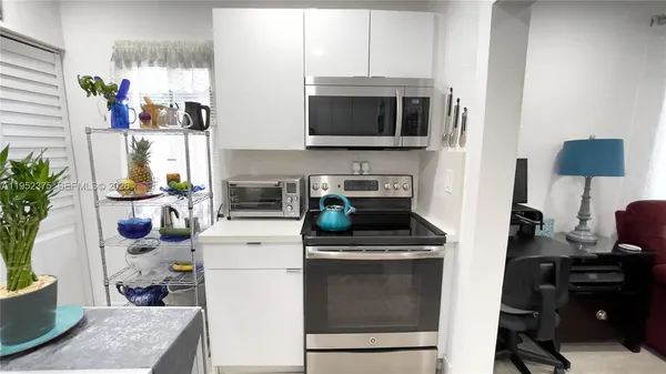 a kitchen with a stove and a microwave
