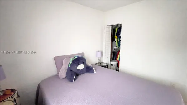 a bedroom with a bed and cabinets