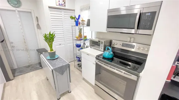 a kitchen with a stove and a microwave