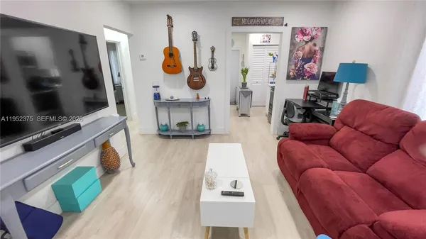 a living room with furniture and a flat screen tv