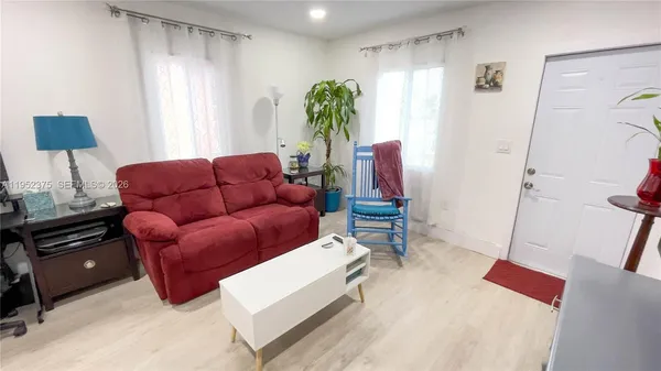 a living room with furniture and a window