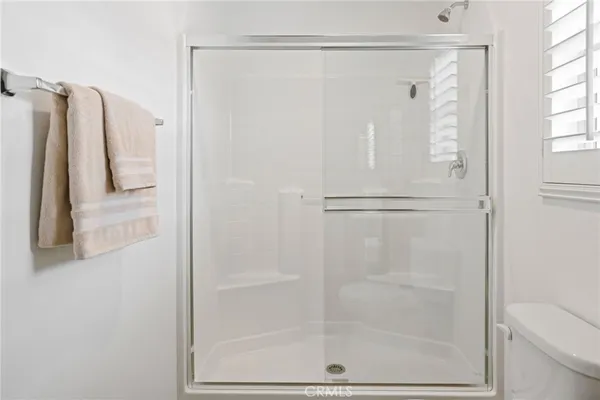 a bathroom with a shower and a toilet