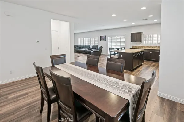 a dining room with furniture and wooden floor