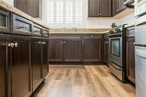 a stove top oven sitting inside of a kitchen