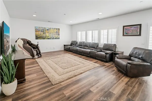 a living room with furniture a flat screen tv and a table