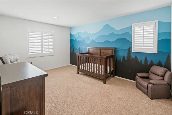 a bedroom with furniture and a window