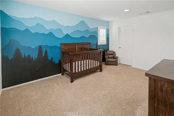 a bedroom with a bed and a tv