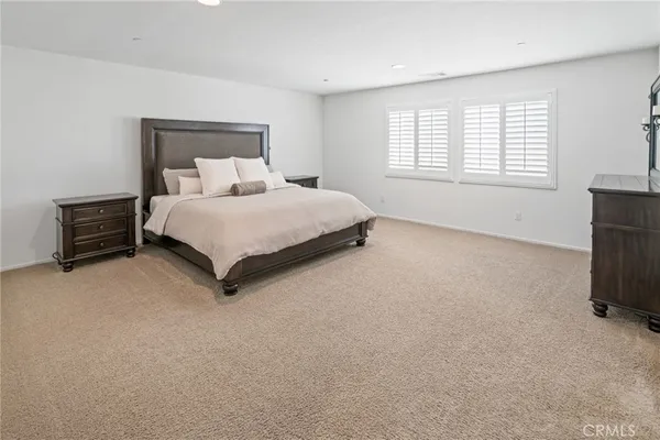 a bed room with a bed and a night stand