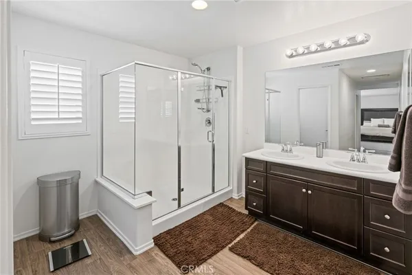 a bathroom with double vanity sinks and a mirror