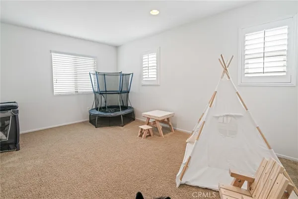 a room with a chair and white walls