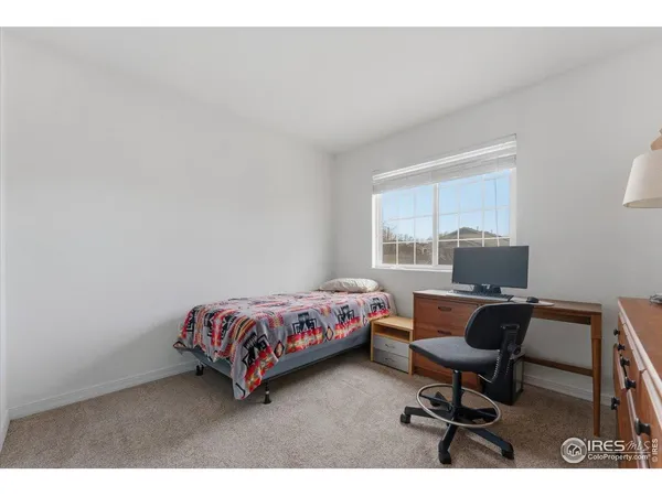 a bathroom with a sink a toilet a large mirror and shower curtain