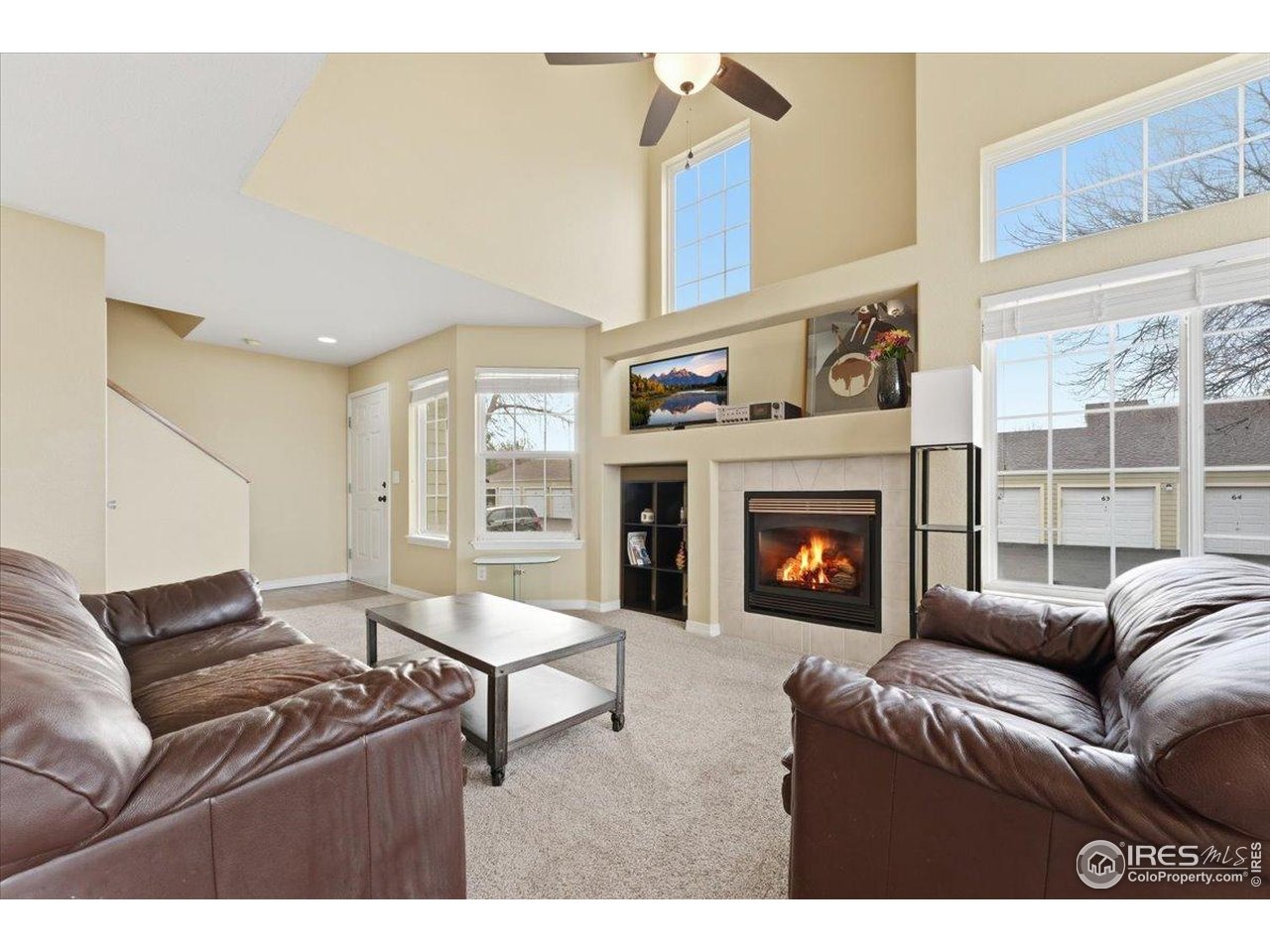 930 Button Rock Drive, Unit 64 Longmont, CO 80504 - Photo 3 of 23 a living room with furniture and a fireplace