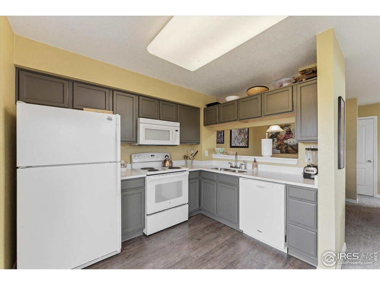 930 Button Rock Drive, Unit 64 Longmont, CO 80504 - Photo 8 of 23 a kitchen with appliances a sink and lots of cabinets