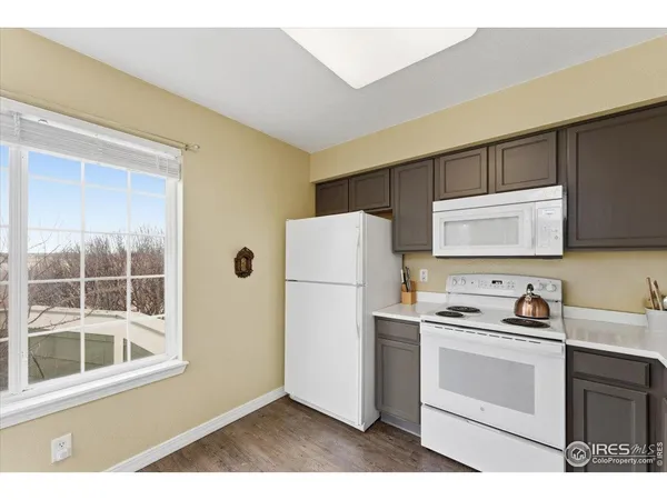 a kitchen with a refrigerator sink and cabinets