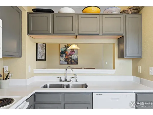 a kitchen sink with granite countertop a sink and a stove