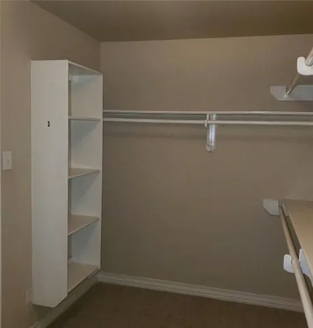a view of an empty walk in closet