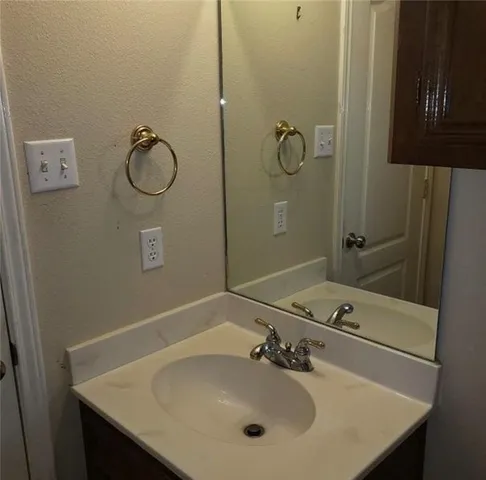 a bathroom with a sink and mirror