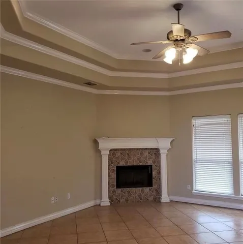 a view of a livingroom with a fireplace and window