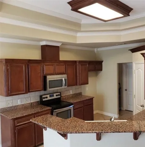 a kitchen with a sink cabinets and stainless steel appliances