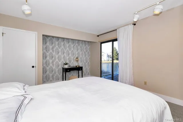 a bedroom with a bed and a potted plant