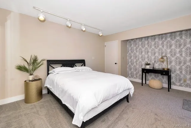 a bedroom with a large bed and a large window